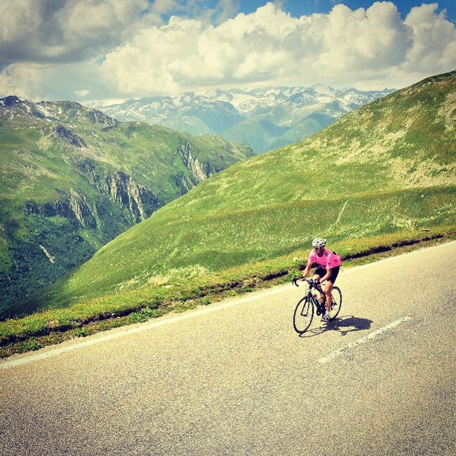 Cycling through lush green Alpine meadows