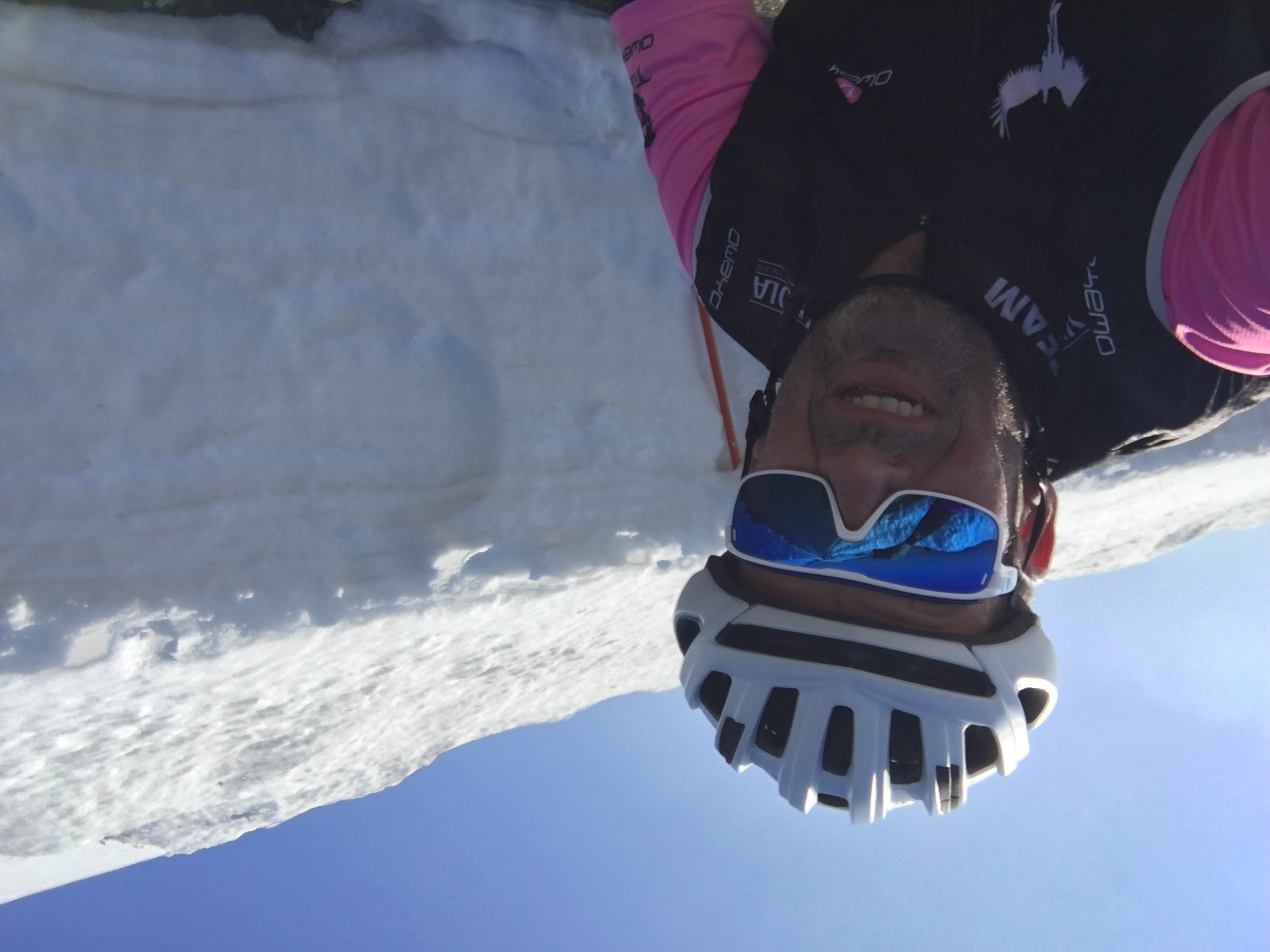 Cyclist next to high snow wall