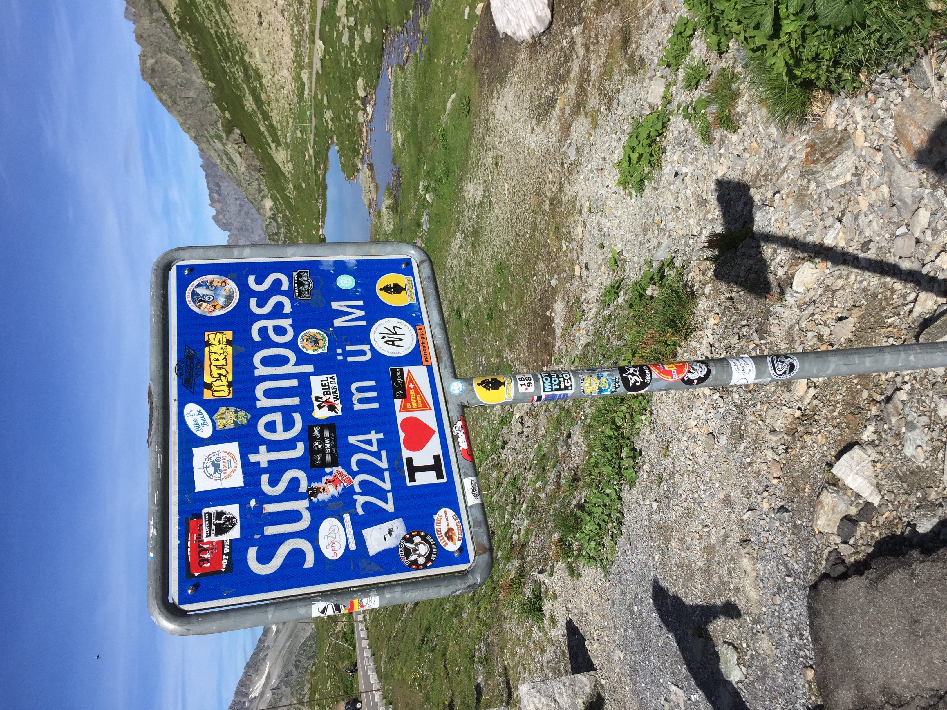 Sustenpass sign with Alpine scenery